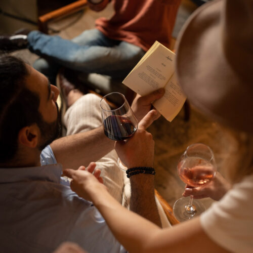 Relaxed atmosphere at Oratio Wine Bar & Library in Florence, where guests enjoy fine wine and literature.