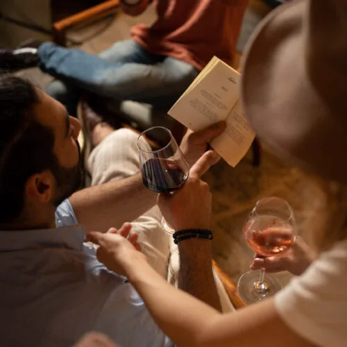 Relaxed atmosphere at Oratio Wine Bar & Library in Florence, where guests enjoy fine wine and literature.